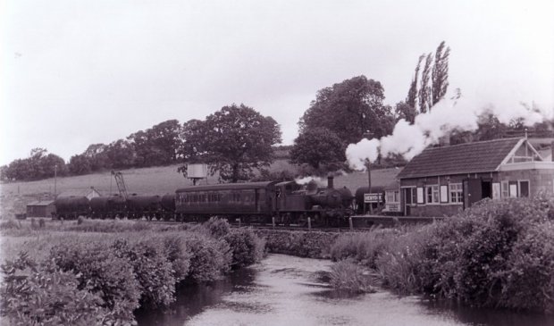 A mixed train waits at Hemyock Station